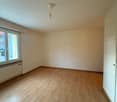 Empty room, wooden floors, white walls, window, ceiling light