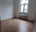 Empty room, hardwood floor, white walls, radiator, large window
