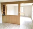Wooden panel, empty room, white walls, wooden floor, window, shelf with items
