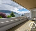 spacious balcony with tile floor, city and mountain views