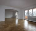 empty room, wooden floor, sliding doors to balcony, radiator, arched opening