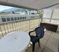 Balcony with table, chair, railing, shade, storage box, panoramic view