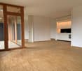 empty room, wooden floor, white walls, sliding doors, balcony, kitchen area