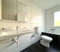 White walls and black floor, sink, toilet, bathtub, mirror, faucet
