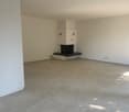 empty room with fireplace and tile flooring