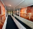 black floor, white walls, Venetian cityscape murals, ceiling lamps, corridor tiles, fire extinguisher