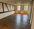 Wooden floor, white walls, windows, beams, heating