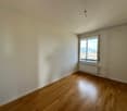 empty room, white walls, large window, wooden floor, white radiator