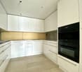 modern kitchen, all white cabinets, black double oven, grey flooring