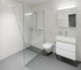 Modern bathroom with white subway tiles, glass shower enclosure, white vanity, and toilet