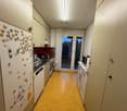 kitchen, refrigerator, cabinets, kitchen appliances, countertop, windows, yellow floor