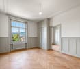 empty room, parquet flooring, white walls, large window with view