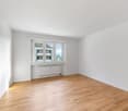 empty room, hardwood floor, white walls, windows, radiator