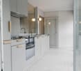 kitchen room, granite countertop, embedded sink, oven, cabinets, faucet, glass door, mirror