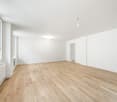 wood floor, large windows, radiator, ceiling lights, empty