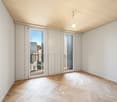 empty room, wooden floor, white walls, sliding glass doors, balcony