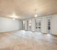 empty room, wooden parquet floor, white walls, wooden ceiling, glass doors, balcony