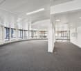 empty room, grey carpet, white walls, circular ceiling, large windows, recessed lighting