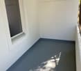 empty room, window, balcony, white walls, gray floor