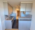 Modern kitchen, stainless steel appliances, granite countertops, double sink, gas stove, extractor fan, built-in oven, wooden flooring