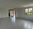 empty room with large windows, balcony access, tiled floor, neutral white walls