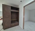 Large wooden closet, empty room, bare walls, unfinished floor