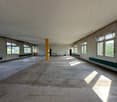empty room, concrete floor, large windows