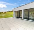 rooftop terrace, panoramic view, sliding glass doors, large glass windows, tiled flooring