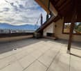 terraced roof with fireplace, closed patio umbrella, overlooking mountain and city
