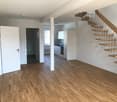 Empty room, wooden floors, white walls, radiator, stairs