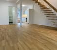 Floor with hardwood flooring, staircase, kitchen area, bathroom