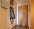 walk-in closet with wooden shelves, clothes, safety deposit box, small cabinet, storage box