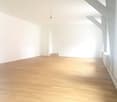 empty room, wooden floor, white walls, sloped ceiling, ceiling beam, doors