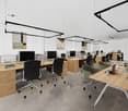 modern office, open layout, minimalist furniture, gray floors, office desks with computers, office chairs, wooden tables, plants, modern ceiling lights, white walls