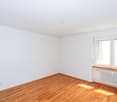 empty room, hardwood floor, white walls, large window, heater