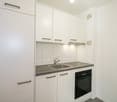all white cabinets, sink, oven, grey countertop, modern