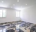 Empty room, white walls, windows, marble floor, recessed lights