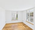 empty room, white walls, wooden floor, 2 windows, ceiling lights