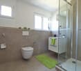 modern bathroom with shower, toilet, washbasin, mirror, window
