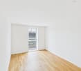 empty room, white walls, wooden floor, sliding glass door with outdoor view