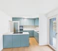 Modern kitchen with blue cabinets, white countertop, glass door to balcony, ceiling lamp, built-in oven and dishwasher