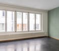 empty room, large windows, white radiator, black floor