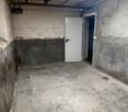 Concrete floor, white walls, ceiling with florescent lighting, white doors, empty room