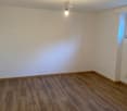 empty room, wooden floor, white walls, single light fixture