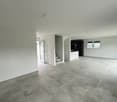 Empty room, white walls, gray tile flooring, glass door, staircase, window