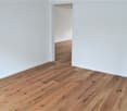 empty room, wooden floor, white walls, door in the center