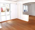 large sliding doors, balcony, wooden floors, white walls, white ceiling