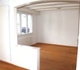 empty room, wooden floor, white walls, large window, radiator