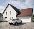modern house, white exterior, brown roof, white garage, brick driveway, car parked in front, large windows