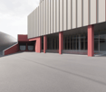 Large commercial building with a modern, minimalist design. The exterior features a combination of gray metal siding and red accents on the columns and entryways. The building has a rectangular shape with a flat roof and large windows. There is a large op